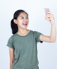 Smiling girl making selfie photo on smartphone