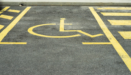 Disabled parking lot with disabled sign in yellow line