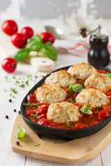 Meatballs with rice in tomato sauce on a light background. Selective focus.