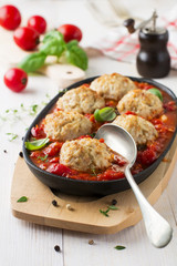 Meatballs with rice in tomato sauce on a light background. Selective focus.