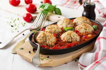 Meatballs with rice in tomato sauce on a light background. Selective focus.
