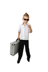 Little boy in business suit and sunglasses with briefcase in hand stays isolated on white background