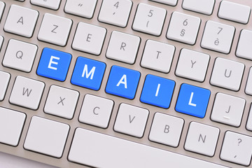 Email in blue on white keyboard