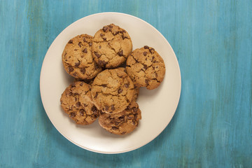 Plate of freshly baked chocolate chips cookies, with copyspace
