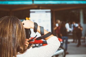 Brunette with camera on moto exhibition