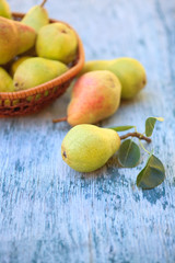 Fresh pears and half pear on the white wooden background. 