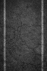 Crack asphalt background a white stripe on the side.