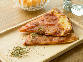 Delicious pizza served on wooden plate