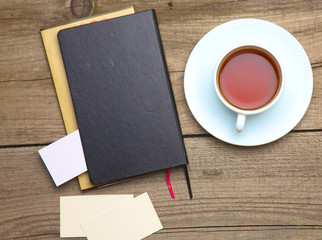 Blank business cards with pen and tea cup on wooden office table