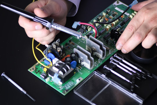 man hands chip soldering tools