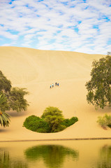 Oasis- Huacachina, a village in southwestern Peru, built around a small oasis surrounded by sand...