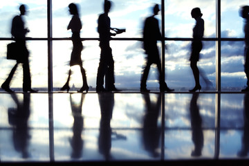 Silhouetted people working in office