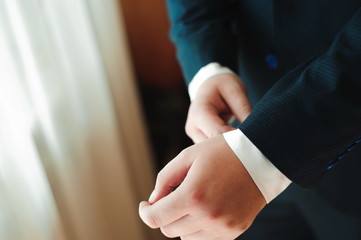 Obraz premium wedding details - elegant groom dressed wedding tuxedo costume