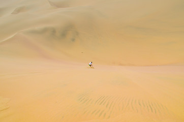 Fototapeta na wymiar Sand-boarding fun on Atacama Desert, Oasis of Huacachina, Ica Region, Peru