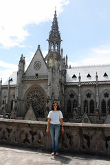 Fototapeta premium woman standing near Basilica of the National in Quito Ecuador
