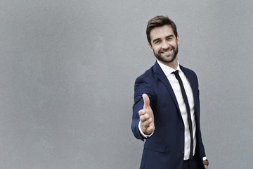 Portrait of businessman ready to shake hands