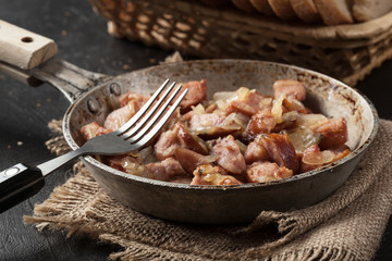 Pieces of sausage fried with onions