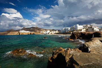 Fototapeta na wymiar View of the Naxos town and one of its beaches.