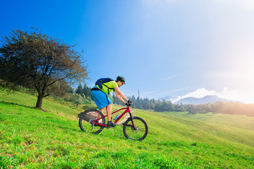 Fototapeta na wymiar A young male riding a mountain bike downhill