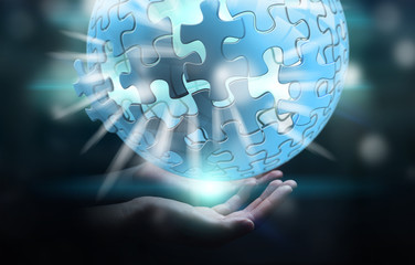 Businessman holding flying puzzle sphere 3D rendering
