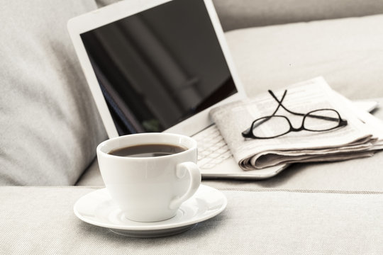 Eyeglasses on laptop and coffee