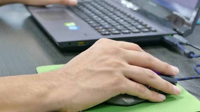 Hands of engineer man with keyboard and hands clicking laptop computer mouse in work.