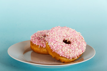 Iced doughnut on a light blue background