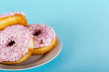 Iced doughnut on a light blue background