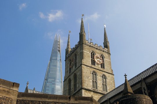 London, Shard skyscraper juxtaposed against Southwark Cathedral, symbol of modern progress
