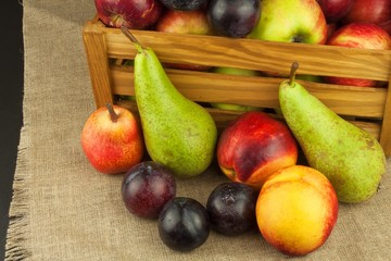 Naklejka na ściany i meble Plum and apples on wooden table. Autumn Fruits. Autumn harvest on the farm. A healthy diet for children. 
