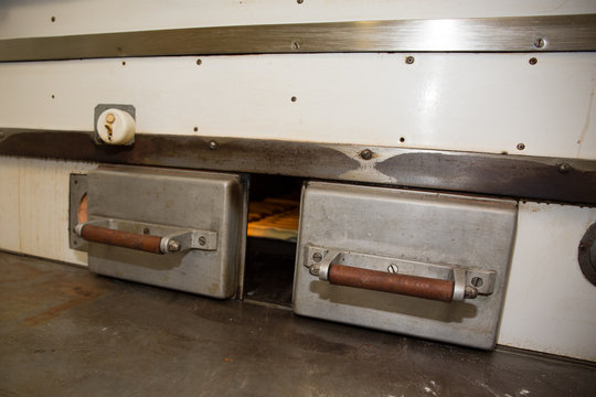Bread rolls baking in oven in a commercial kitchen