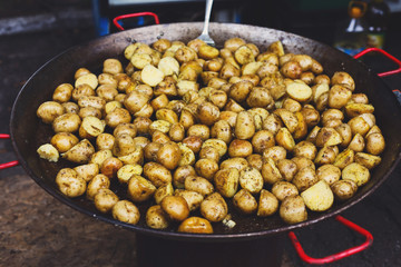 Roasted potatoes cooked in metal cauldron pot