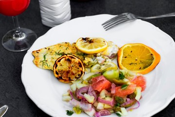 Grill fish with salad and citrus