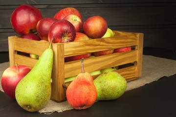 Fototapeta na wymiar Pears and apples on wooden table. Autumn Fruits. Autumn harvest on the farm. A healthy diet for children. 