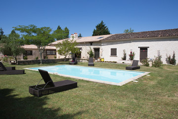 Blue Pool near the house on a background of deep blue sky