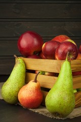 Pears and apples on wooden table. Autumn Fruits. Autumn harvest on the farm. A healthy diet for children.
