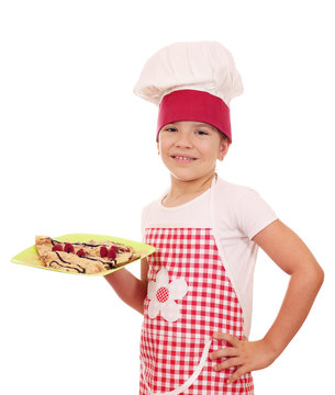 happy little girl cook with sweet crepes on plate