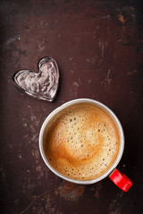 coffee in unusual vintage tin mug with glass heart