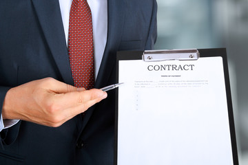 Business man is offering to sign  a contract, business contract