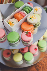 Colorful macaron cookies on bar for sale