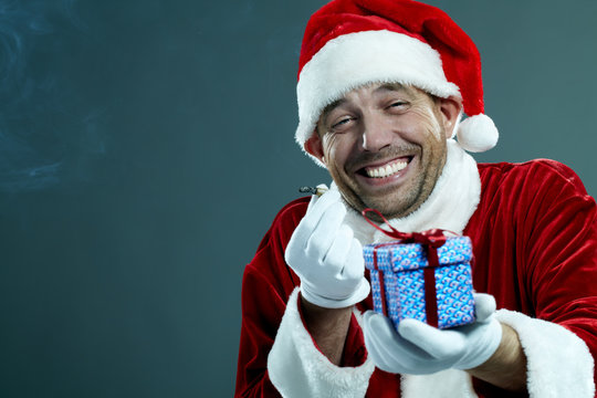 Man In Santa Costume And With Cigarette Laughing Hysterically