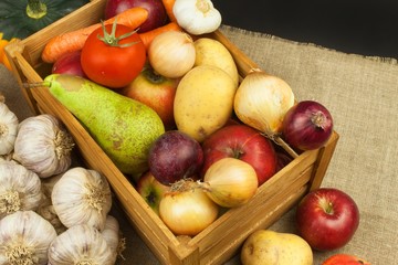Vegetables and apples on wooden table. Autumn harvest on the farm. A healthy diet for children.

