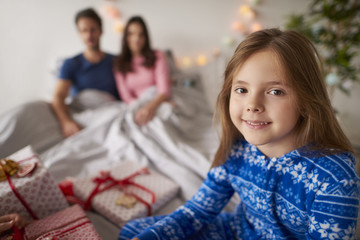 Little girl waiting for opening Christmas presents