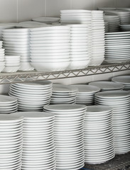 many white plates on a wire rack