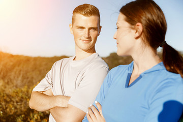 Young couple on beach in sportwear