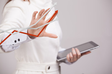 Businesswoman working with growth graph on grey background