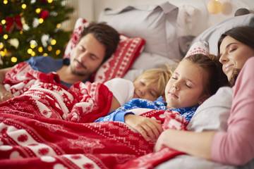Family sleeping in Christmas morning