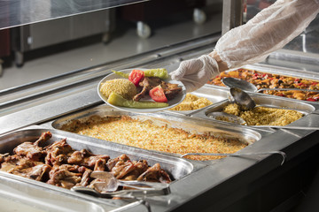 chef standing behind full lunch service station