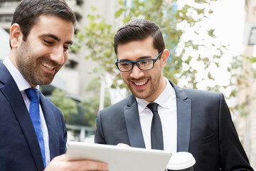 Two businessmen talking outdoors