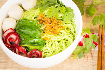 Noodles in Thailand Ba-Mee-Moo-Dang or pasta of Asia on wooden table.Close up and top view.
